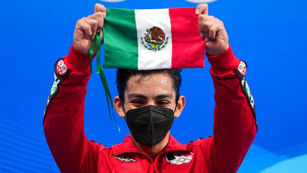 Donovan Carrillo, of Mexico, gestures after competing in the men's free skate program during the figure skating event at the 2022 Winter Olympics, Thursday, Feb. 10, 2022, in Beijing. (AP Photo/David J. Phillip)
